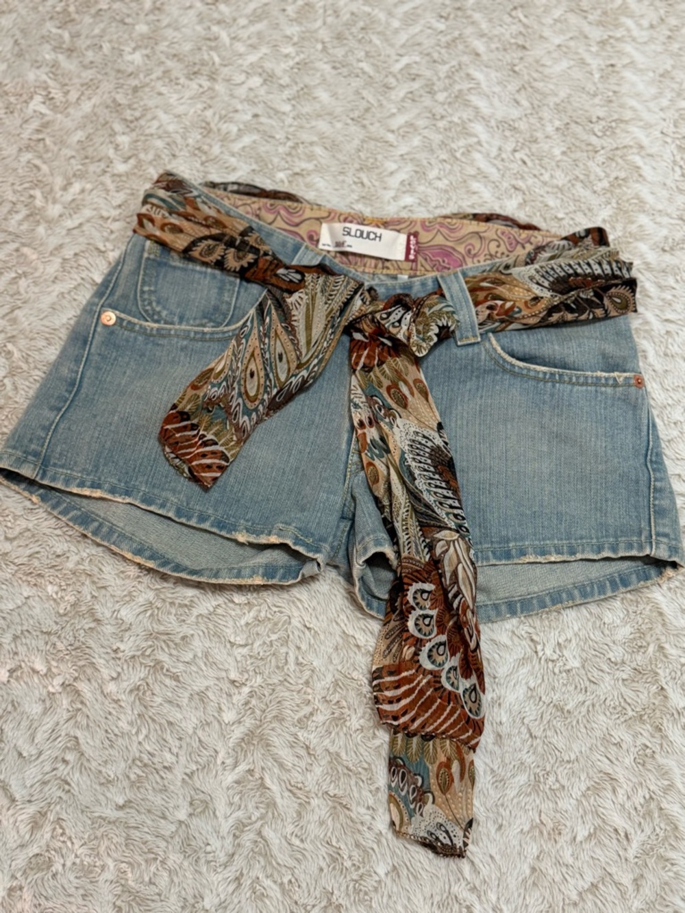 Levi's blue denim vintage shorts with patterned scarf belt.